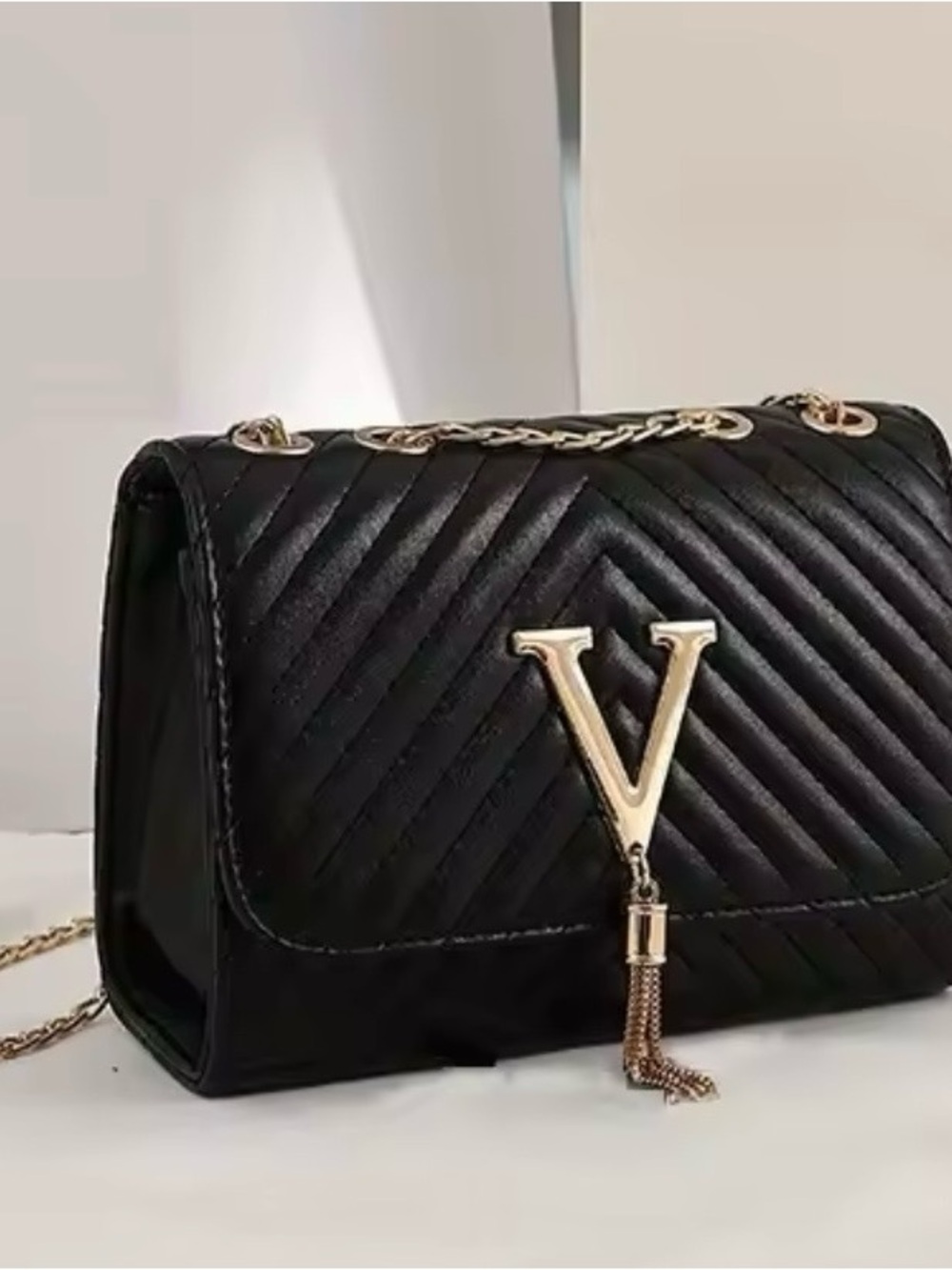 Black Quilted Shoulder Bag with Gold V Tassel